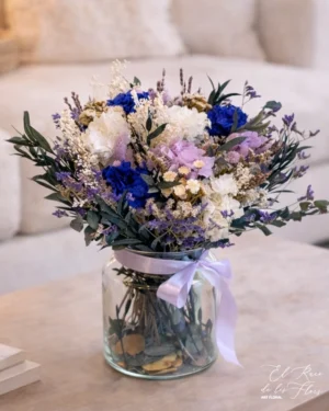 Jarrón de cristal con bouquet en tonos turquesa y azul marino. Materiales utilizados hortensia preservada, eucalipto preservado parvifolia, eucalipto preservado cinerera Medidas del jarrón 19cm altura x 14cm diámetro Medidas del ramo 36cm diámetro. Altura total 38cm