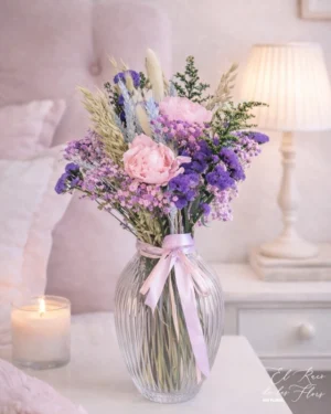 conjunto de estilo dulce y romántico, en tonos rosa y lila. Materiales utilizados peonía rosa preservada, solidalgo, statice y panículata. Medidas jarrón 27cm altura x 17cm Medidas ramo 28cm altura total 48cm